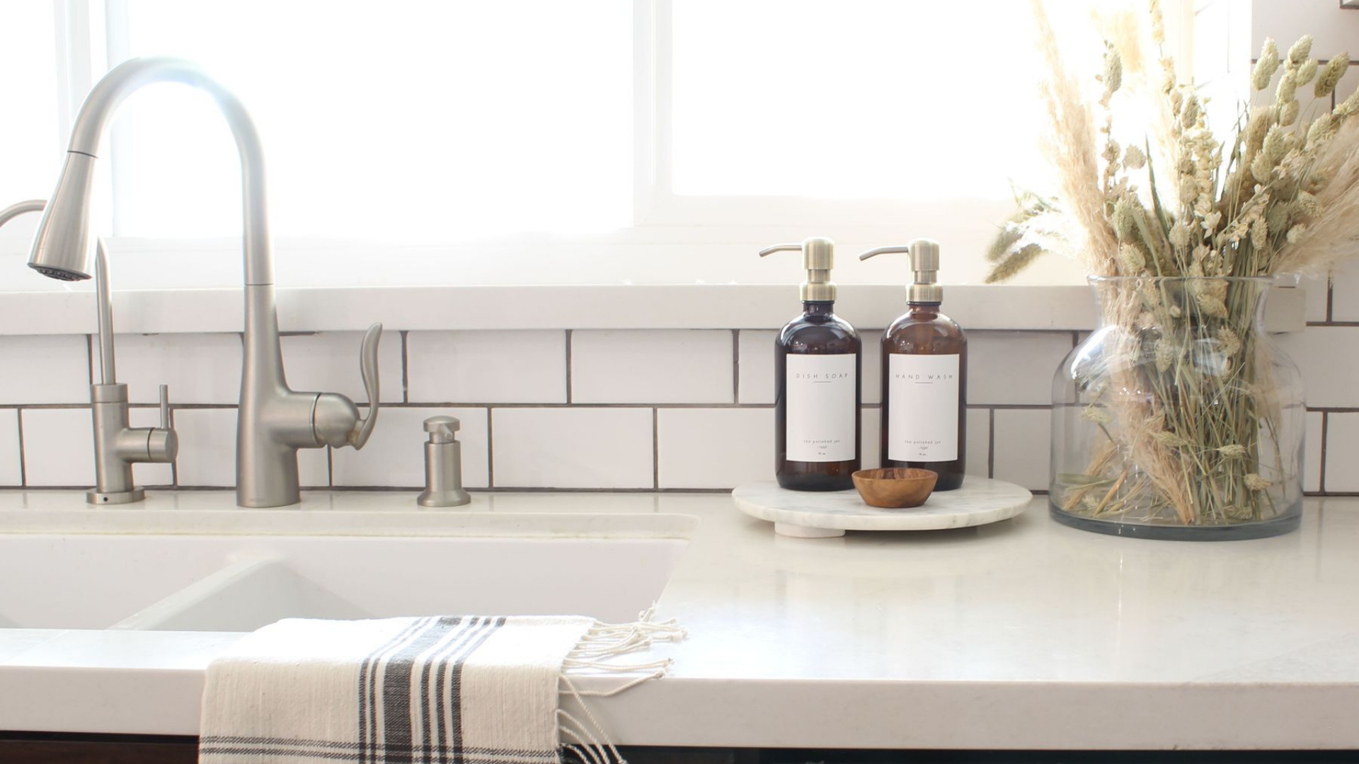 White Kitchen Counter With The Polished Jar Dispenser on tray