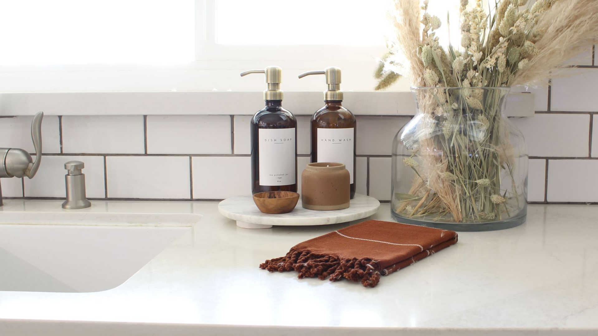 The Polished Jar Amber Glass Bottle Soap Dispensers on Kitchen Counter