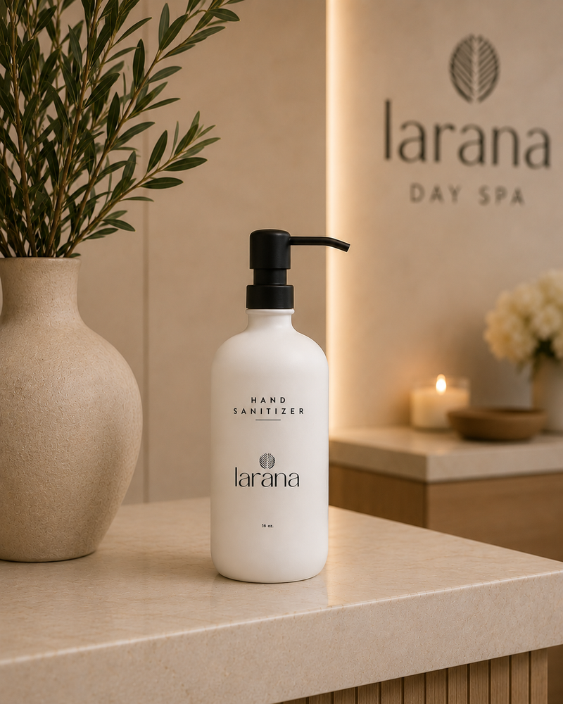 Larana hand sanitizer bottle on a counter with a blurred background of a spa setting.
