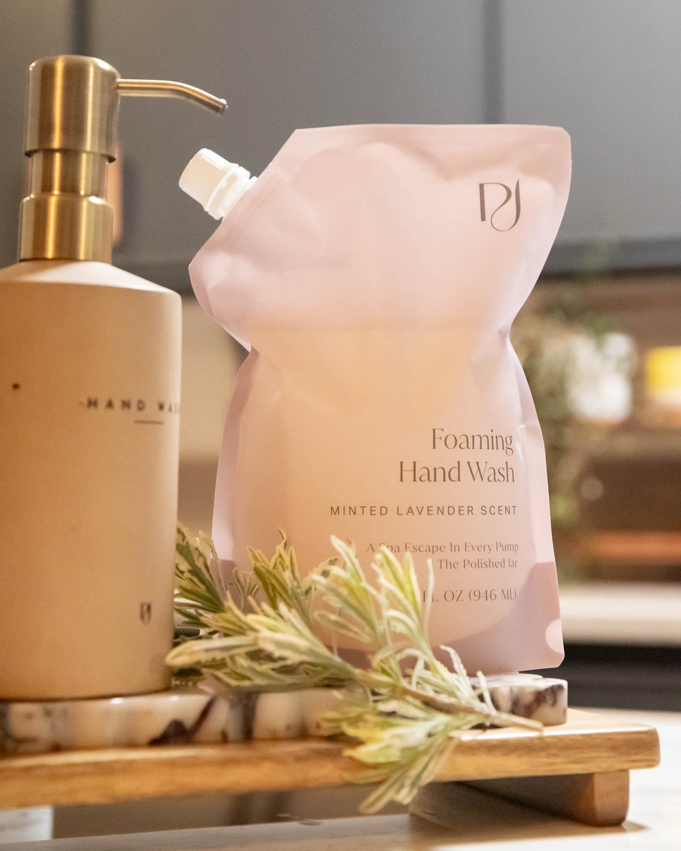 Foaming hand wash bottle and pump dispenser on a wooden tray with a blurred background