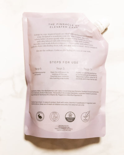 Back of a soap packaging with text and icons on a white background