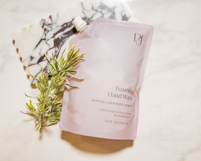 Foaming hand wash packaging with a plant on a marble surface