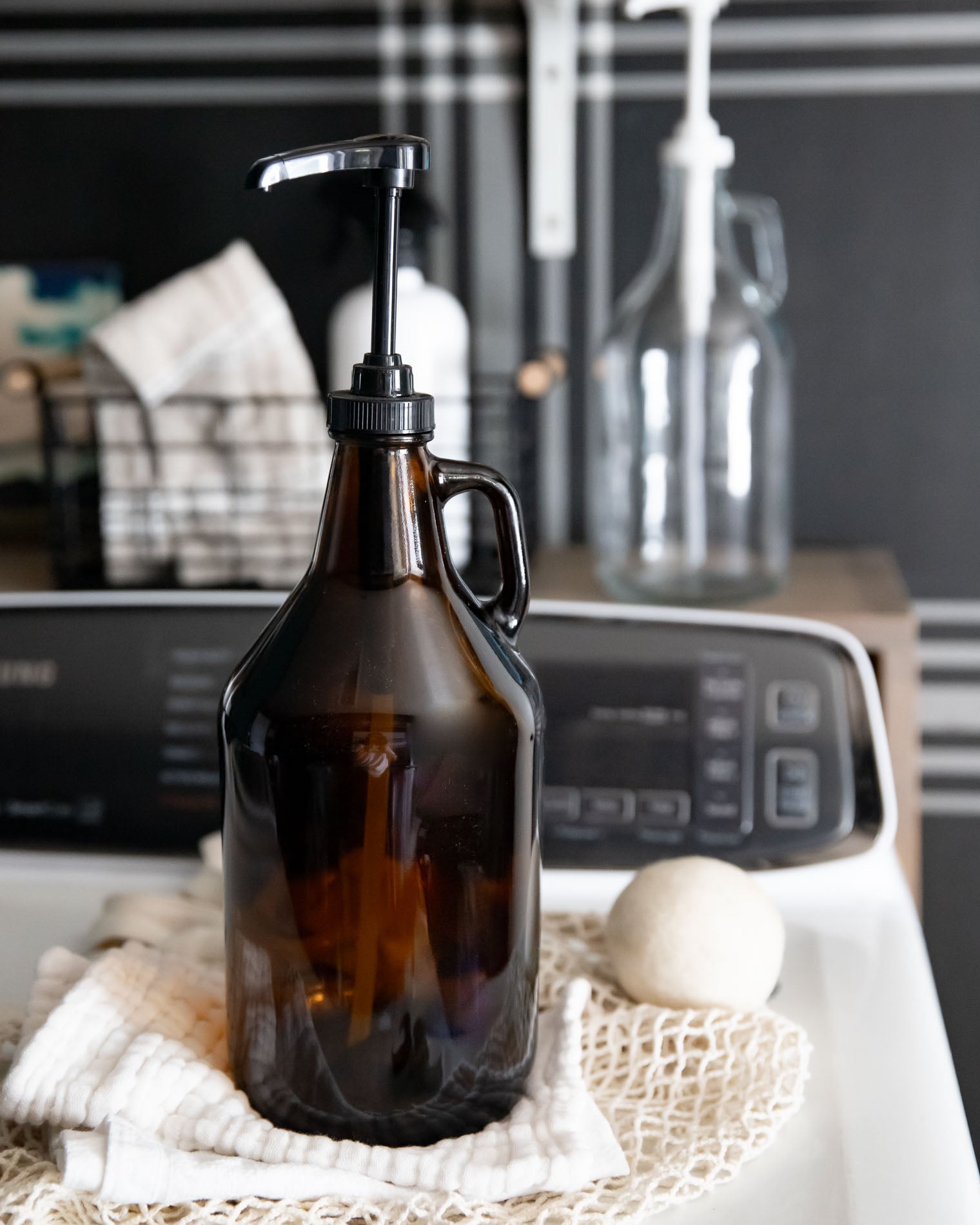 Brown glass bottle with black pump on a kitchen counter