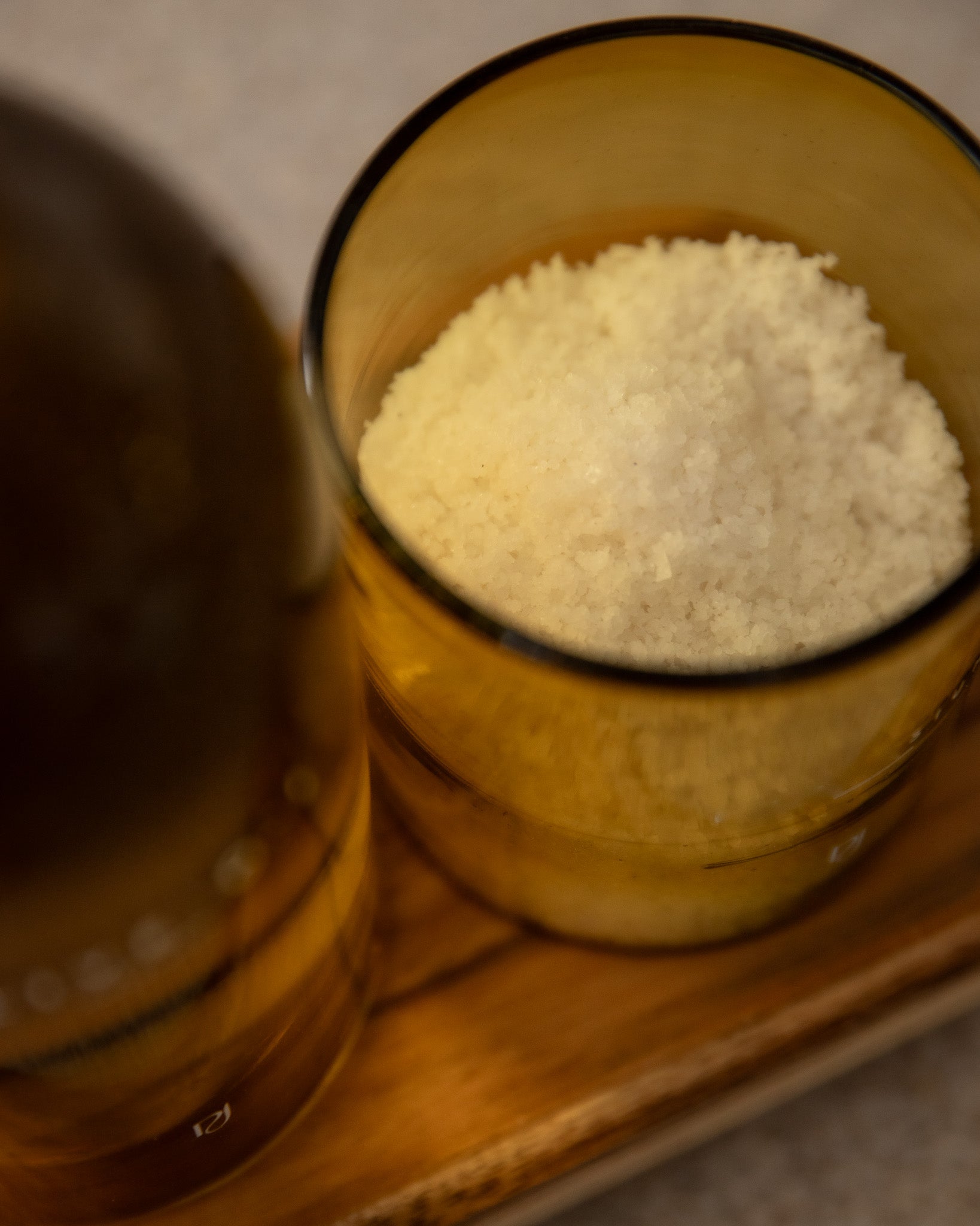 HandBlown Glass container with Celtic salt on a wooden surface