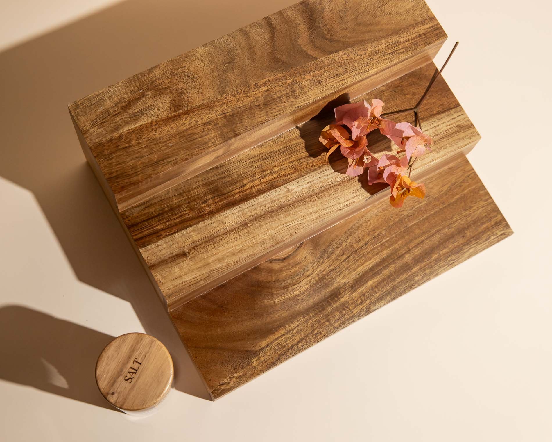 Wooden spice rack with flowers on a beige background