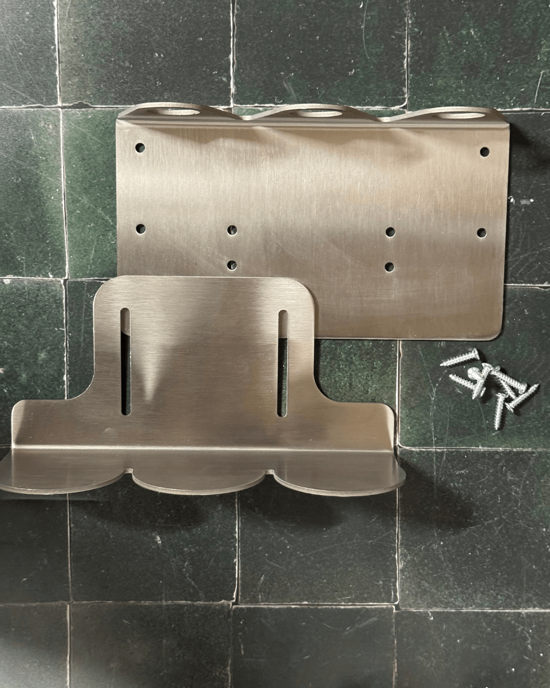 Metal wall-mounted shower caddy on a tiled bathroom wall